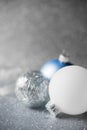 Blue, silver and white xmas ornaments on glitter holiday background. Merry christmas card. Royalty Free Stock Photo