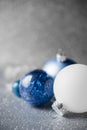 Blue, silver and white xmas ornaments on glitter holiday background. Merry christmas card. Royalty Free Stock Photo