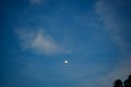 Blue skies with clouds and evening moon