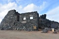 Blue skies on a dark stoned gold mining ruins