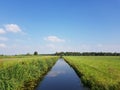 Blue skies sky over countryside and canal near Rotterdam, Holland Royalty Free Stock Photo