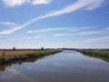 Blue skies sky over countryside road and windmill near Rotterdam, Holland Royalty Free Stock Photo