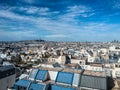 Blue skies and wispy clouds over the Paris rooftops; tiny Scre Coeur in distance Royalty Free Stock Photo