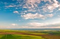 Blue sky and white clouds over green field