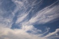 Blue sky background with big white tiny stratus cirrus striped clouds Royalty Free Stock Photo