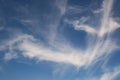 Blue sky background with big white tiny stratus cirrus striped clouds Royalty Free Stock Photo