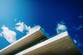 Blue sky background with clouds and a roof of modern financial business building Royalty Free Stock Photo