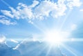 Blue sky background with clouds and sun rays coming out Royalty Free Stock Photo