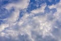 Blue sky background with cumulus white clouds and looming storm clouds