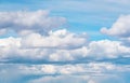 Blue sky background with fluffy huge clouds. Stormy sky with fluffy clouds. Sunny blue sky background with clouds.