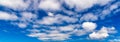 Blue sky background with fluffy white clouds Royalty Free Stock Photo