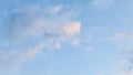 Blue sky background with pale pink clouds at sunset Royalty Free Stock Photo