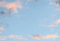 Blue sky background with pale pink clouds at sunset Royalty Free Stock Photo