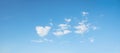 Blue sky background with some fluffy clouds, one in a heart shape