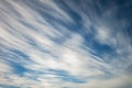 Blue sky background with tiny stratus cirrus striped clouds. Clearing day and Good windy weather Royalty Free Stock Photo