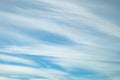 Blue sky background with tiny stratus cirrus striped clouds. Clearing day and Good windy weather Royalty Free Stock Photo