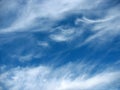 Blue sky background with wavy fleecy clouds Royalty Free Stock Photo