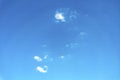 Blue sky background with white clouds.