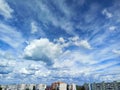 Blue sky with beautiful clouds over urban high-rise buildings