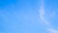 A blue sky with beautiful wisp of cloud for use as a backing or backdrop Royalty Free Stock Photo