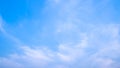 A blue sky with beautiful wisp of cloud for use as a backing or backdrop Royalty Free Stock Photo