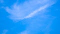 A blue sky with beautiful wisp of cloud for use as a backing or backdrop Royalty Free Stock Photo