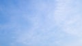 A blue sky with beautiful wisp of cloud for use as a backing or backdrop Royalty Free Stock Photo