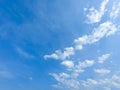 A blue sky with beautiful wisp of cloud for use as a backing or backdrop Royalty Free Stock Photo
