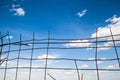 Blue sky behind the broken metal fence Royalty Free Stock Photo