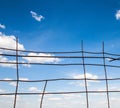 Blue sky behind the broken metal fence Royalty Free Stock Photo