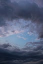 Blue sky behind dark storm clouds background texture Royalty Free Stock Photo