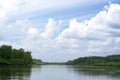 Blue sky on a calm summer day. Bend of the river in Siberia  forest near water Royalty Free Stock Photo