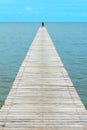 Blue sky clear with perspective wooden bridge extending into the sea at resort,couple happiness and relax in summer on holiday Royalty Free Stock Photo