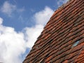 Blue sky with cloud and dark red brick roof Royalty Free Stock Photo