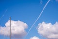 Blue sky cloud mast and airplane contrail