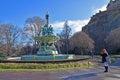 Two tourists taking selfies in front of Edinburgh Castle and Ross Fountain in Princes Street Gardens Royalty Free Stock Photo