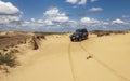 Ukraine, Kherson region, Oleshky Sands - June 2011: 4x4 jeep in the sand desert.