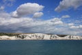 Blue sky with clouds and in the distance Dover in England in the summer.