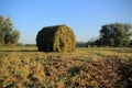 Blue sky with clouds on a misty day and bales of hay in the park in the autumn. Royalty Free Stock Photo