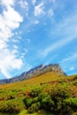 Blue sky, clouds and mountain at countryside for environment, sustainability and summer growth. Nature, beauty and hill Royalty Free Stock Photo