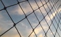 Blue sky with clouds through a net.