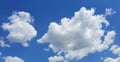 Blue Sky with Clouds, one Bigger and one Smaller on a Bright Sunny Day