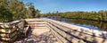 Blue sky and clouds over a bridge that crosses Henderson Creek, which runs through Rookery Bay