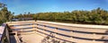 Blue sky and clouds over a bridge that crosses Henderson Creek, which runs through Rookery Bay