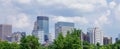 Blue sky with clouds over the Minneapolis skyline and green trees Royalty Free Stock Photo