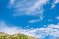 Blue sky and clouds over the rocks Royalty Free Stock Photo