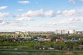 blue sky with clouds over roofs of city illuminated by morning sun Royalty Free Stock Photo