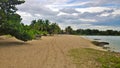 Blue sky and clouds over a tropical beach with green trees in Playa Larga, Cuba. Royalty Free Stock Photo