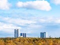 Blue sky with clouds over yellow forest and houses Royalty Free Stock Photo