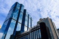 Blue sky and clouds reflected on the glass of office business buildings in the city center on a bright sunny day Royalty Free Stock Photo